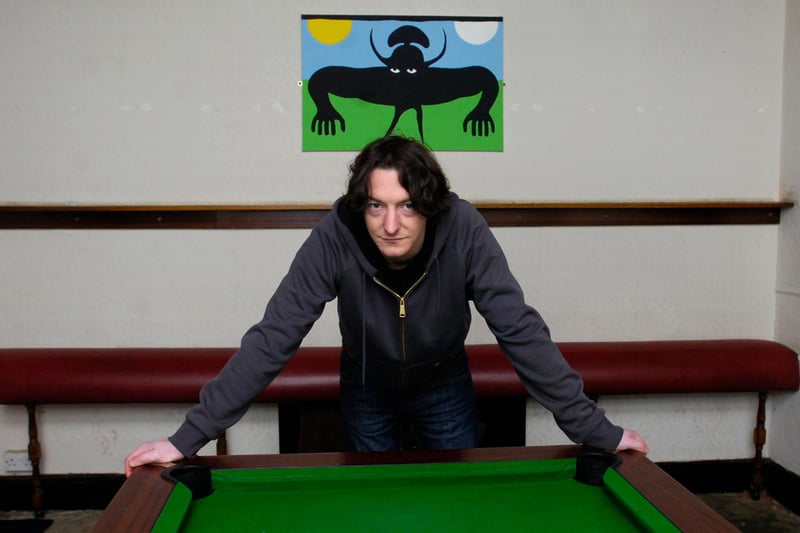 Jeff Boss at The Shakespeare pub on Gibraltar Street, Sheffield, standing in front of a ghoulish figure in the pool room where people have reported seeing ghosts