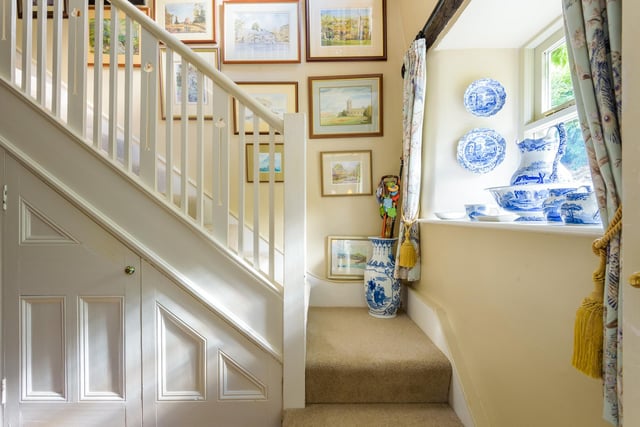 Just next to the front door is the hallway, which contains storage and access to the downstairs loo. It's also where you can find the stairs to the bedrooms.