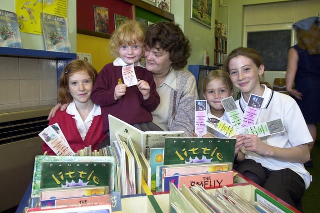 During National Book Week in 2001 Kate Grimes presented bookmarks to, from left, Abigail Highfield, aged nine, of Edlington, Chloe Grimes, aged four, of Warmsworth, Robyn Darbyshire, aged seven, of Edlington, and Jessica Highfield, aged ten, of Edlington. Kate, of Edlington, is grandma to Robyn and Chloe.