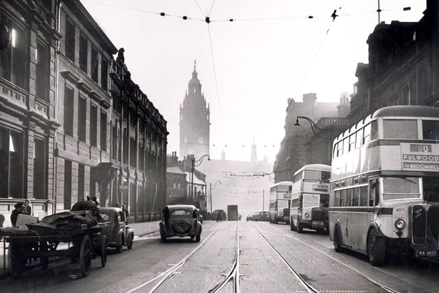 Buses and cars travel along Leopold Street, Sheffield, in 1947