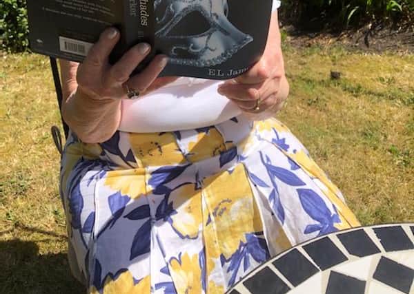 Violet caught by the family reading an 'exotic' book.