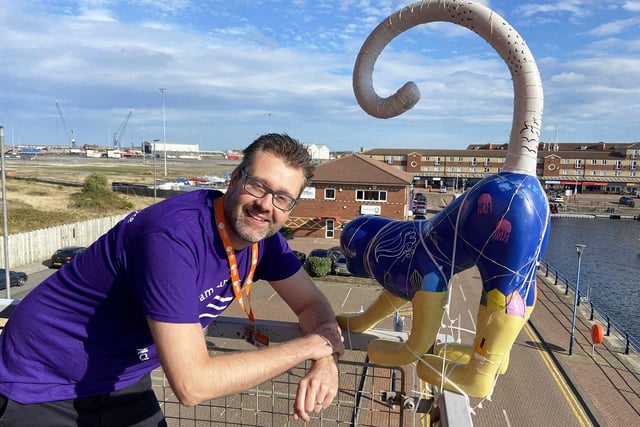 Glen Hughes on the balcony at Orangebox Training Solutions with their distinctive sculpture. Picture by FRANK REID