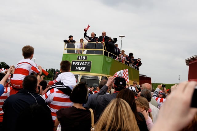 The open top bus parade makes its way through the crowds at the Keepmoat