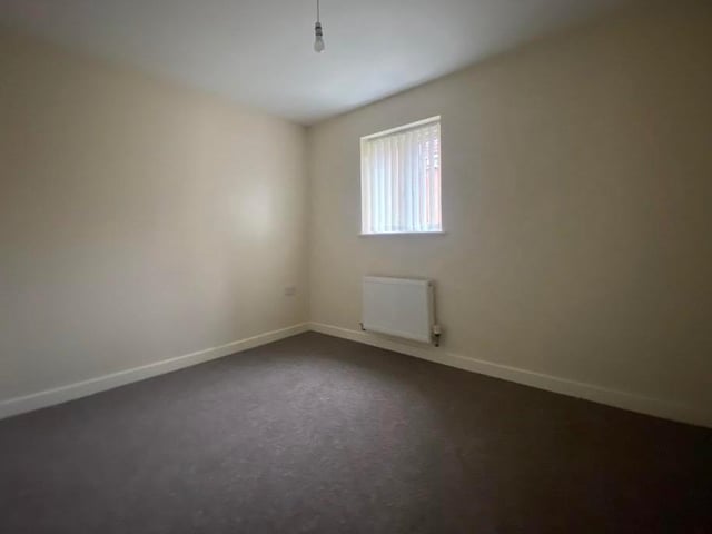 The second bedroom is slightly smaller than the other, but still a decent size. It has a window to the side, a carpeted floor and a double radiator.