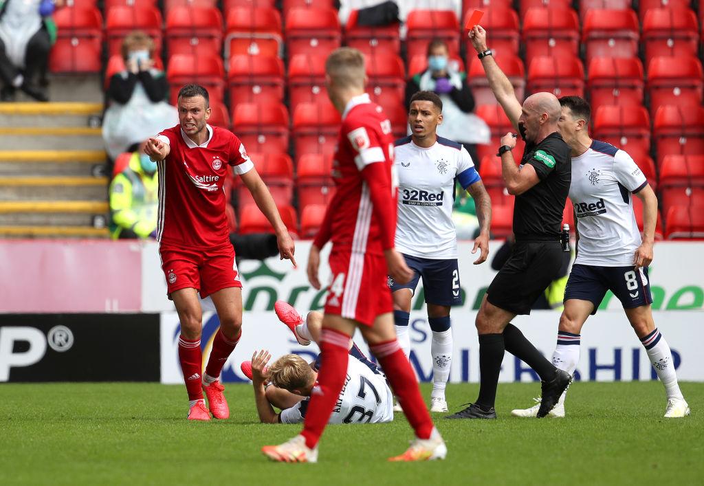 Andrew Considine of Aberdeen is shown a red card by referee Bobby Madden after fouling Scott Arfield of Rangers FC. (Photo by Andrew Milligan/Pool via Getty Images)