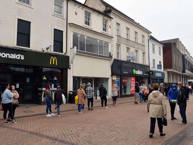 Shoppers queue to enter Primark.