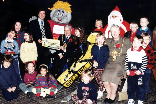 Managing director of Sheffield Ski Village, John Fleetham, presents the Lord Mayor of Sheffield with a gift voucher for a ski lesson on their specially-adapted skis for the disabled.  The Lord Mayor and Mayoress were attending an early Christmas party with pupils from Dobcroft Infant and Junior Schools, November 1997
