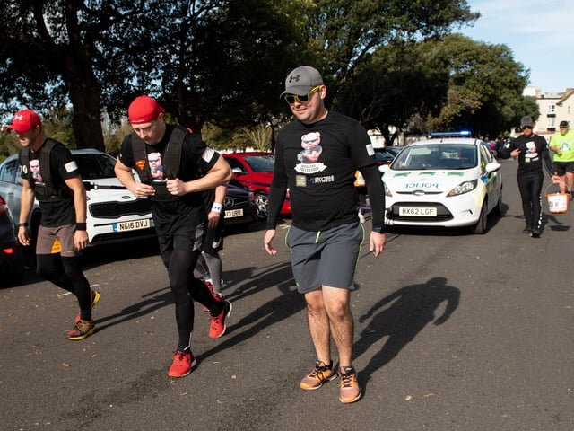 The police team pulling a police car around the course. (201019-293)