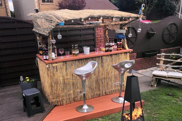 Lorraine Davidson sent us this brilliant Tiki Bar pic, complete with a bench made from driftwood.