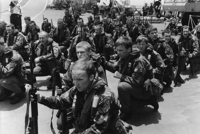 Royal Marines waiting on the flight deck of HMS Hermes for Sea King helicopters to take them on training manoeuvres, April 1982. (Photo by Martin Cleaver/Pool/Getty Images)
