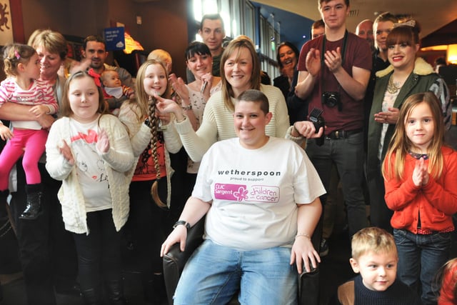 Kim Dale (seated) gets her long hair cut by Kimberley Metter for charity in 2013. And she followed it with a complete head shave at the Lambton Worm in Low Row, Sunderland.