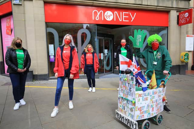 John Burkhill took his first walk around Sheffield today with the help of staff from Virgin Money on Fargate. Picture: Chris Etchells