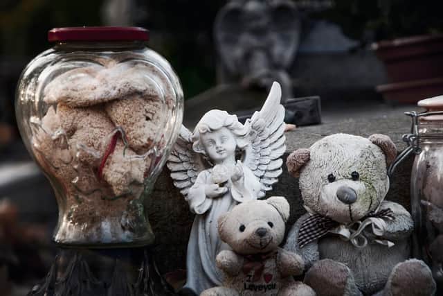 A baby's body was exhumed due to repeated thefts from their grave and vandalism