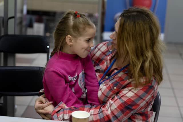 RZESZOW, POLAND - MARCH 21: Sofia Kluchko, 5, spends time with her mother, Victoria Kluchko, at a relief center set up for people fleeing the war in Ukraine on March 21, 2022 in Rzeszow, Poland. Victoria said they fled the town of Sumy where they lived. Nearly two-thirds of the more than 3 million people to have fled Ukraine since Russia's invasion last month have come to Poland, which shares a 310-mile border with its eastern neighbor. (Photo by Joe Raedle/Getty Images)