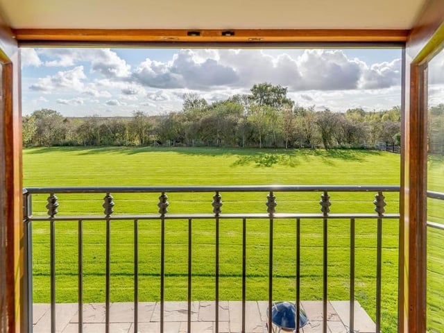 The master bedroom offers pleasant views of the property's gardens and paddock land. Something special to wake up to every morning!