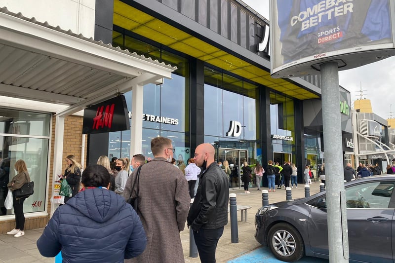 Customers flock to shopping centres in Edinburgh as restrictions on non-essential retail lift from today. Here are some keen shoppers pictured outside JD Sports at Fort Kinnaird.