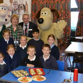 Wallace and Gromit with schoolchildren in uniform