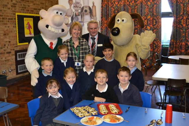 Wallace and Gromit with schoolchildren in uniform