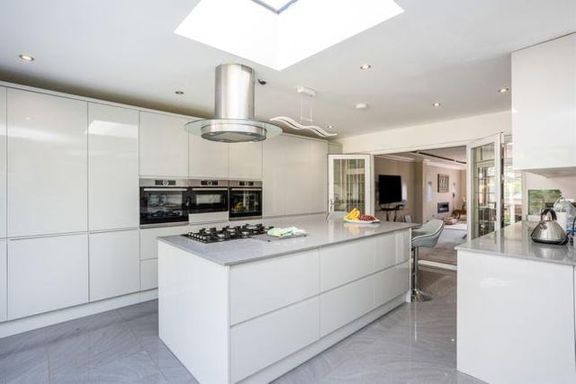 The large kitchen diner is bright and modern, featuring a breakfast island and two sets of bi-folding doors which lead to the rear garden
