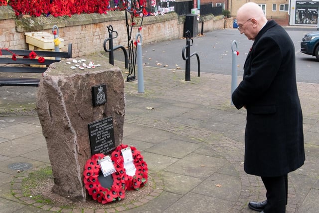 Coun John Wilmott lays his wreath at Market Place war memorial