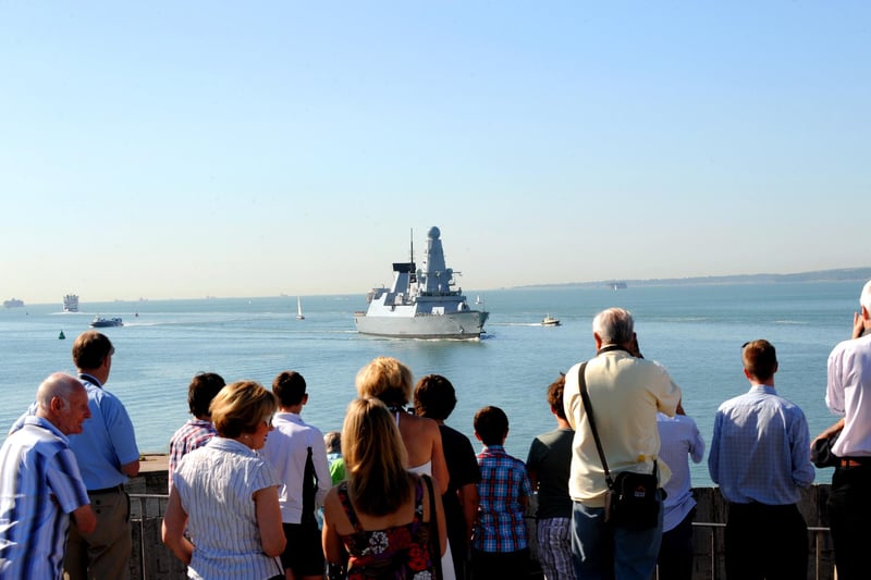 25th July 2012. Crowds welcome the Navy's newest destroyer HMS Defender as she arrives in her home port of Portsmouth. Picture: Sarah Standing (122488-9787)