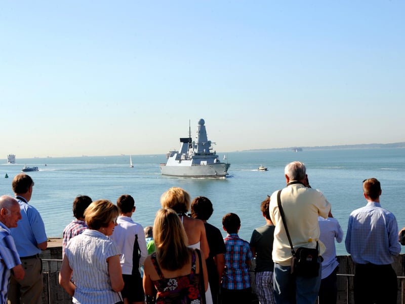 25th July 2012. Crowds welcome the Navy's newest destroyer HMS Defender as she arrives in her home port of Portsmouth. Picture: Sarah Standing (122488-9787)