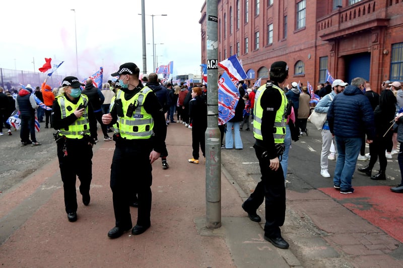 Police arrive at the Ibrox Stadium as fans gather to celebrate Rangers winning the Scottish Premiership title.