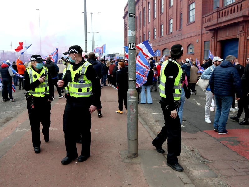 Police arrive at the Ibrox Stadium as fans gather to celebrate Rangers winning the Scottish Premiership title.