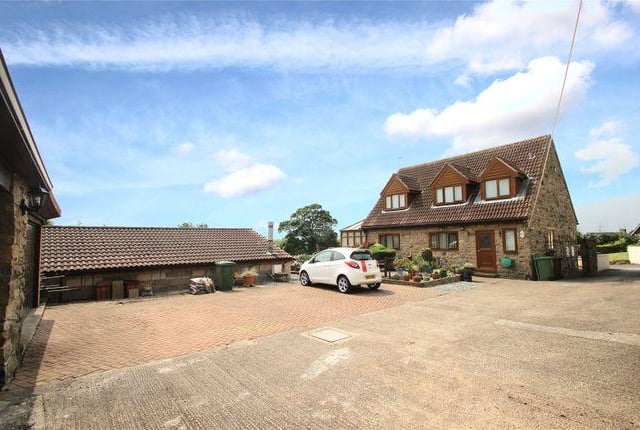 This three bedroom bungalow has an indoor heated swimming pool and a balcony with views.