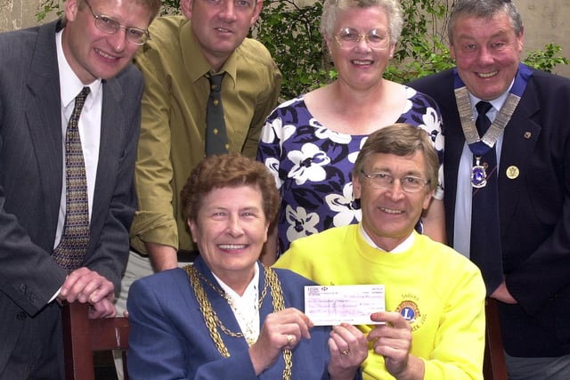 Doncaster Lions Club has presented £1,5000 to the St John's Hospice in 2000. The money was raised from a sponsored 90 miles walker over six days in the northern Sahara desert. Our picture shows Paul Ashcroft handing over the cheque to the Mayor of Doncaster, Councillor Maureen Edgar, watched by, from left, Mark Toseland, Paul Wilson, Mary Kingston, and Lions Club president Colin Kingston. The presentation took place at the Mansion House