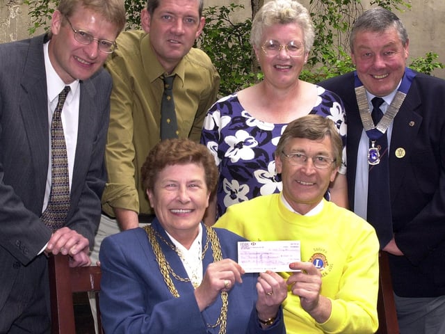 Doncaster Lions Club has presented £1,5000 to the St John's Hospice in 2000. The money was raised from a sponsored 90 miles walker over six days in the northern Sahara desert. Our picture shows Paul Ashcroft handing over the cheque to the Mayor of Doncaster, Councillor Maureen Edgar, watched by, from left, Mark Toseland, Paul Wilson, Mary Kingston, and Lions Club president Colin Kingston. The presentation took place at the Mansion House