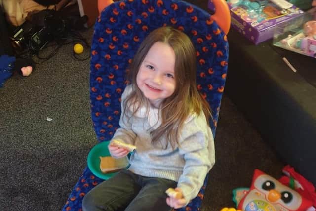 Ivy immediately jumped into her Stagecoach bus seat after she tore off the wrapping paper.