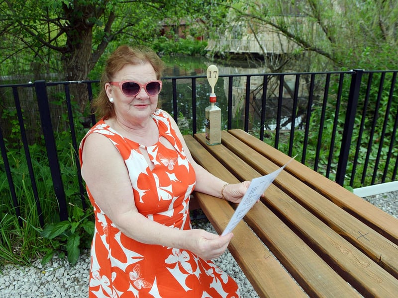 Customer Jean Warner examines the cafe's menu of quiches, cakes, Ploughman's lunches in the new garden area complete with waterside views.