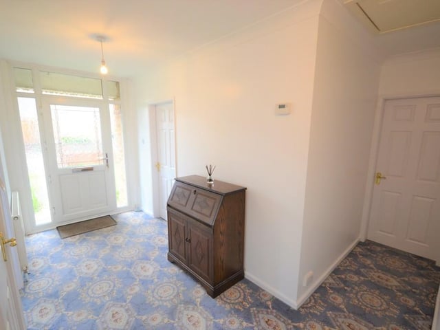 Reception Hall - A spacious area for greeting guests with matching gloss white six panel doors opening to the breakfast kitchen, sitting room, all three bedrooms and the family shower room, there is a power socket, central heating radiator, alarm control panel, loft access and coving to the ceiling.