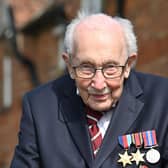 British World War II veteran Captain Tom Moore, 99, poses doing a lap of his garden in the village of Marston Moretaine, 50 miles north of London, on April 16, 2020. - A 99-year-old British World War II veteran Captain Tom Moore on April 16 completed 100 laps of his garden in a fundraising challenge for healthcare staff that has "captured the heart of the nation", raising more than £13 million ($16.2 million, 14.9 million euros). "Incredible and now words fail me," Captain Moore said, after finishing the laps of his 25-metre (82-foot) garden with his walking frame. (Photo by JUSTIN TALLIS / AFP) (Photo by JUSTIN TALLIS/AFP via Getty Images)