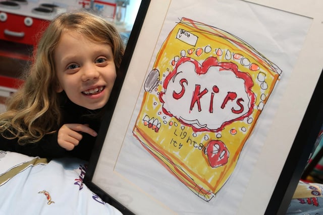 Chloe Daykin is pictured with the framed artwork 'Skips' which was recently sold.