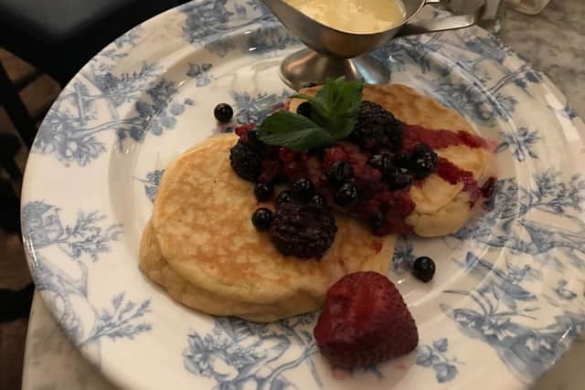 Pancakes with frozen berries and white chocolate sauce at Bill's.