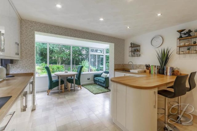 The kitchen leads directly into a sitting-room, which offers a stunning view of the back garden all year round. Additionally, you will find a handy utility-room and a WC nearby on the ground floor.