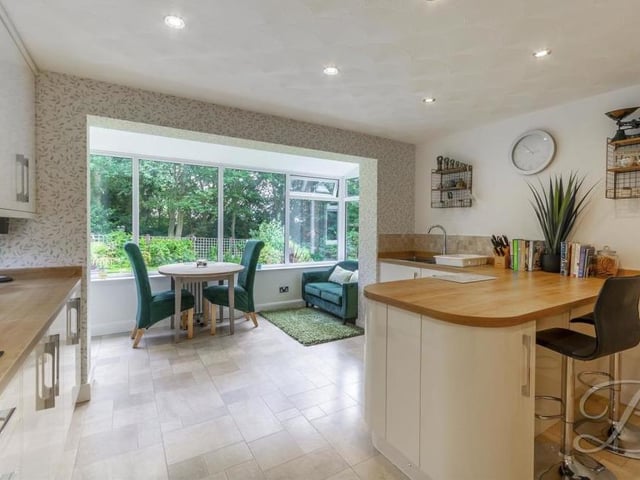 The kitchen leads directly into a sitting-room, which offers a stunning view of the back garden all year round. Additionally, you will find a handy utility-room and a WC nearby on the ground floor.