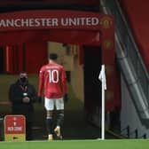 Manchester United's Marcus Rashford leaves the game against Liverpool with an injury: Martin Rickett/PA Wire.