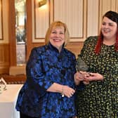 Karen Johnson (left) presents Stacey Burgess with her award