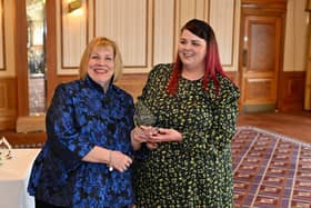 Karen Johnson (left) presents Stacey Burgess with her award