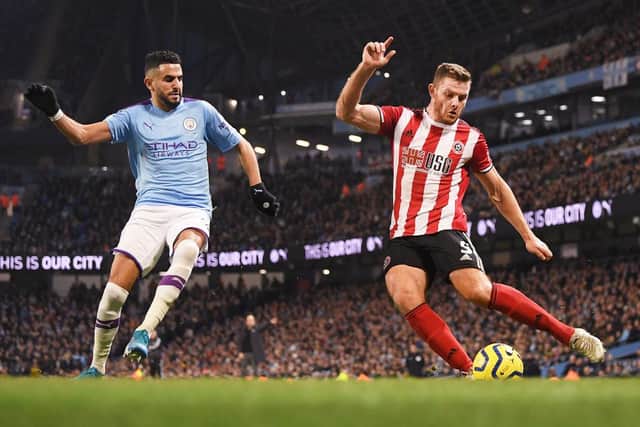 Riyad Mahrez of Manchester City looks on as Jack O'Connell of Sheffield United controls the ball during the Premier League match between Manchester City and Sheffield United at Etihad Stadium on December 29, 2019 in Manchester,: Michael Regan/Getty Images