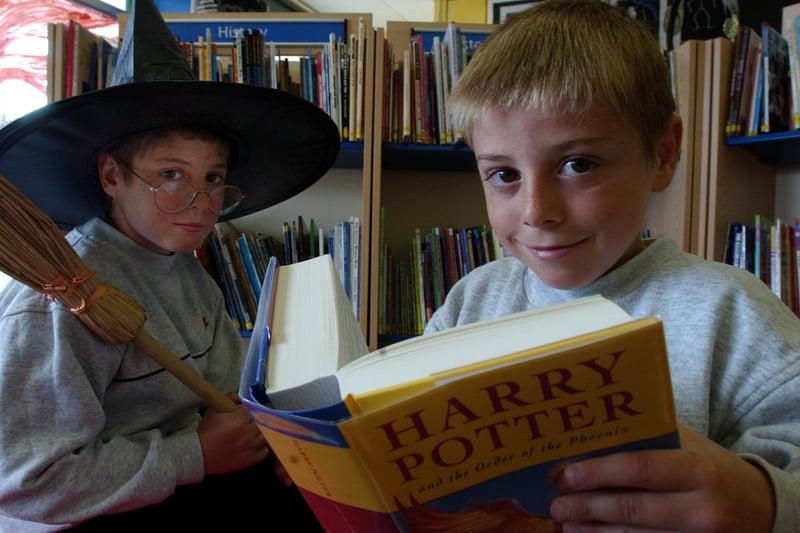 Andrew and Dylan Charlton get stuck in to a Harry Potter book at the Central Library 18 years ago.