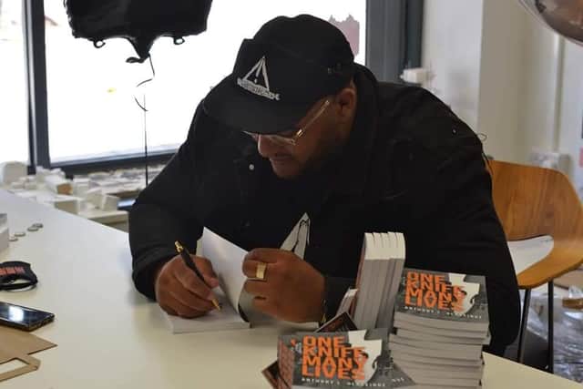 Anthony signing books.
