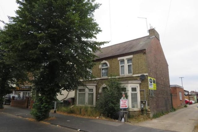 This plot of land is on sale for £1.25m, which includes three commercial units and a detached house which is currently separated into three flats.