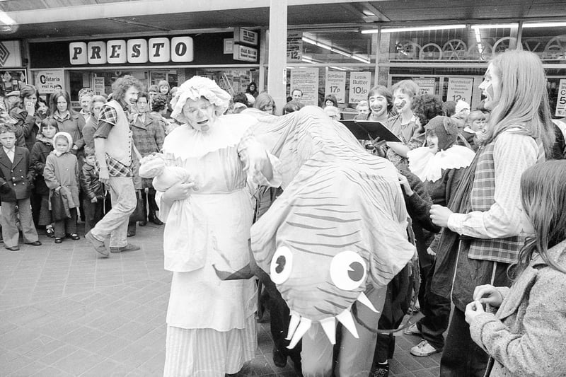 This picture from 1974  depicts a performance of the Lambton Worm in Market Square, Sunderland, as part of the Wearmouth 1300 Festival. The hero of the tale, John Lambton, is said to have caught nothing but the small worm while fishing. Having dumped it in a well the worm grew into a giant serpent which dined on sheep and the occasional human. John returns from Jerusalem to fight the serpent.