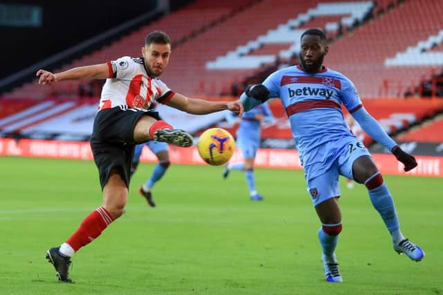 George Baldock has a shot on goals for SHeffield United in the early stages of their Premier League match against West Ham at Bramall Lane  (Photo by MIKE EGERTON/POOL/AFP via Getty Images)