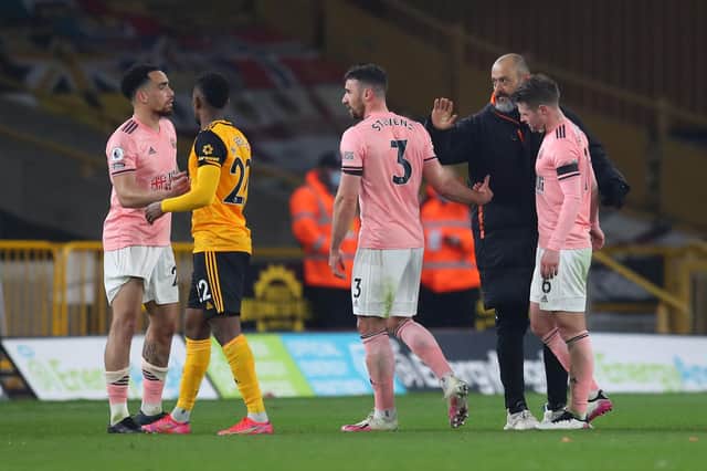 Nelson Semedo and Nuno Espirito Santo, manager of Wolverhampton Wanderers, console Kean Bryan, Enda Stevens and Oliver Norwood of Sheffield United after defeat confirmed Sheffield United's relegation from Premier League (Photo by Catherine Ivill/Getty Images)
