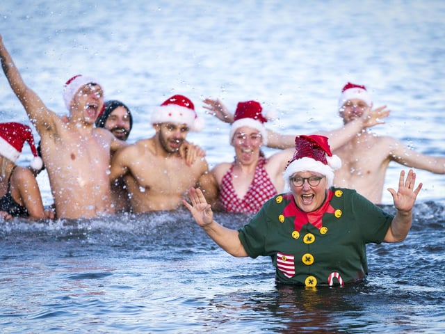 Julie Gannucci (right), from Portobello, takes a dip with her family in the Firth of Forth at Portobello Beach in Edinburgh on New Year's Day. Picture date: Saturday January 1, 2022. PA Photo. Photo credit should read: Jane Barlow/PA Wire